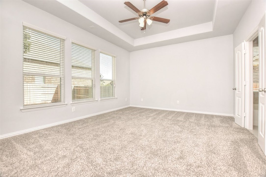 704 Bonnet Boulevard Georgetown, TX 78628 - Photo 21 of 40 Spacious master bedroom facing the backyard
