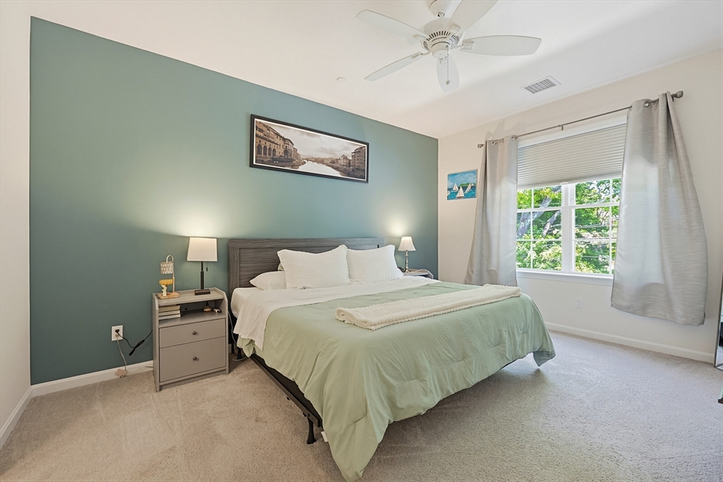200 Revere Street, Unit 4209 Canton, MA 02021 - Photo 19 of 35 a spacious bedroom with a bed and a large window