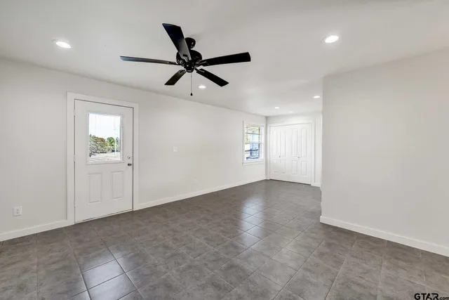 a view of a big room with a ceiling fan