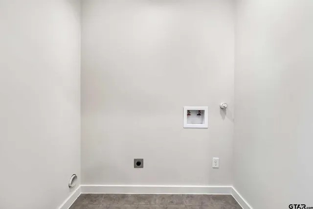 an empty room with ceiling fan and windows