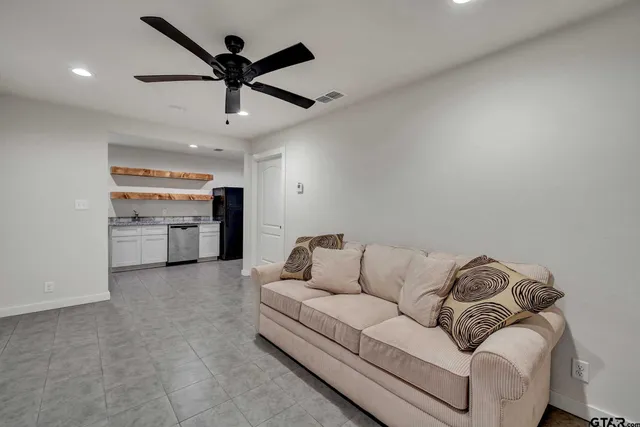 en empty room with a ceiling fan and fan