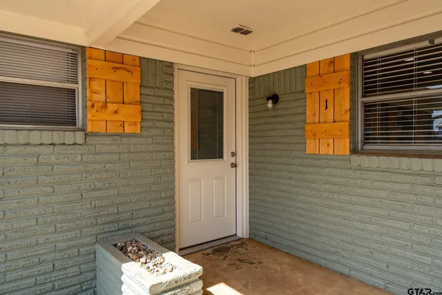 a view of a terrace with chairs and wooden fence