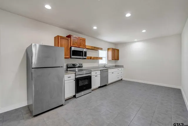 a kitchen with stainless steel appliances granite countertop a sink and a microwave