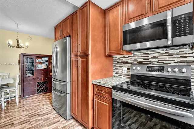 a kitchen with stainless steel appliances a refrigerator stove and microwave