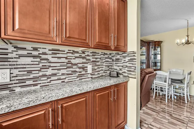 a kitchen with granite countertop a sink and cabinets