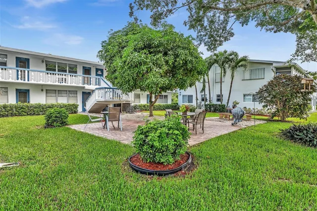 a swimming pool with outdoor seating and yard