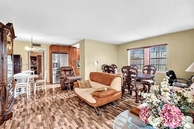 a living room with furniture a rug and a window