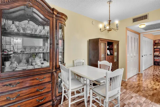 a view of a dining room with furniture and chandelier