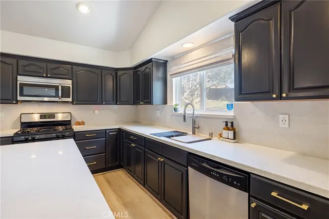 a kitchen with a sink stove and microwave