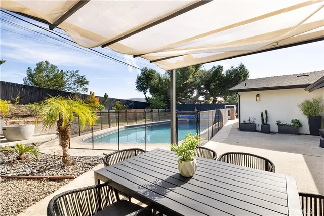 a view of a patio with table and chairs potted plants with wooden floor