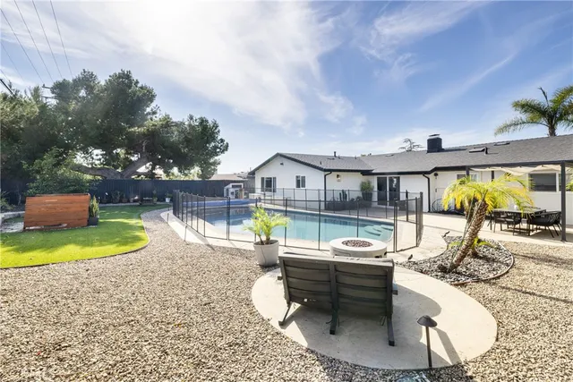 swimming pool view with a seating space