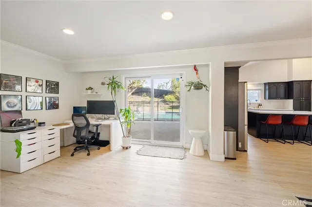 a view of a livingroom with workspace and a window