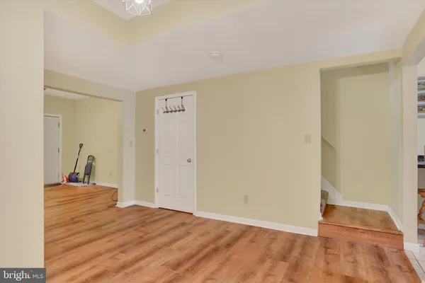 a view of a room with wooden floor and a sink