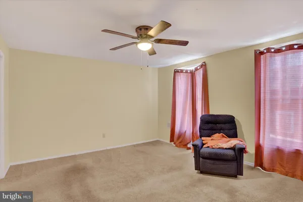 a bedroom with a bed and a ceiling fan