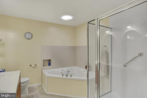 a bathroom with a tub a sink and a toilet