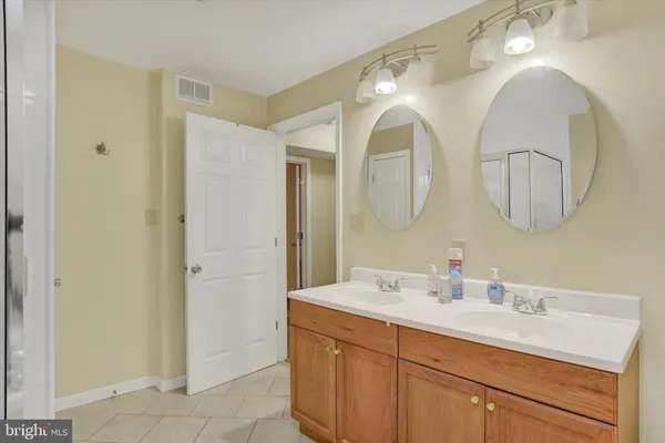 a bathroom with a double vanity sink and a mirror