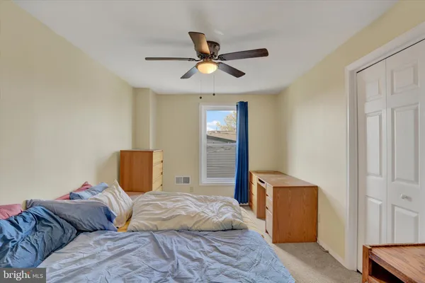 a bedroom with a bed and window