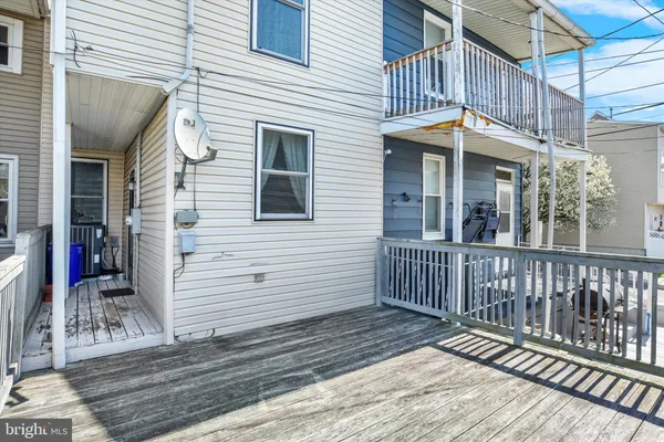 a view of a house with wooden deck