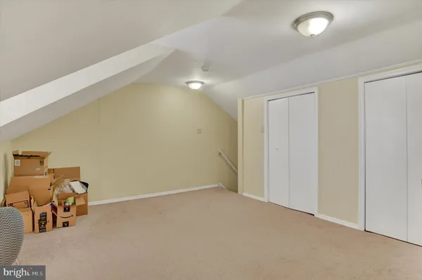 an empty room with piano and wooden floor