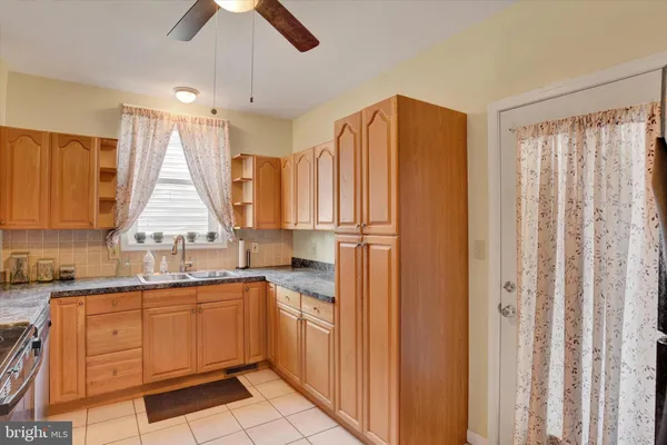 a kitchen with a sink a window and stainless steel appliances