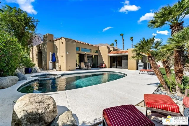 a view of a patio with couches table and chairs and potted plants