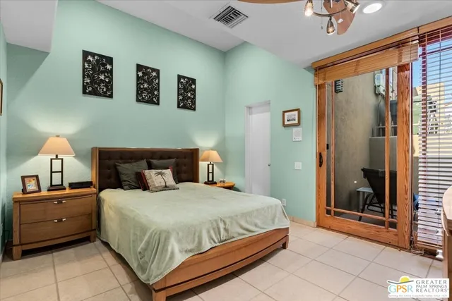 a bedroom with a bed and a painting on the wall