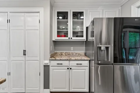 a kitchen with stainless steel appliances a sink stove refrigerator and cabinets