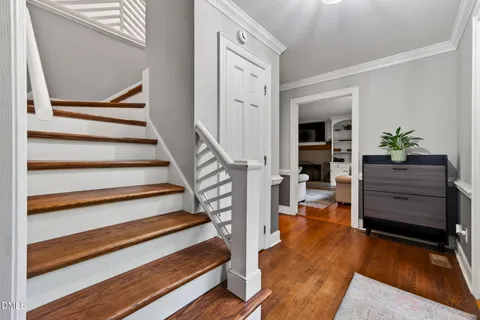 a view of entryway with wooden floor and stairs