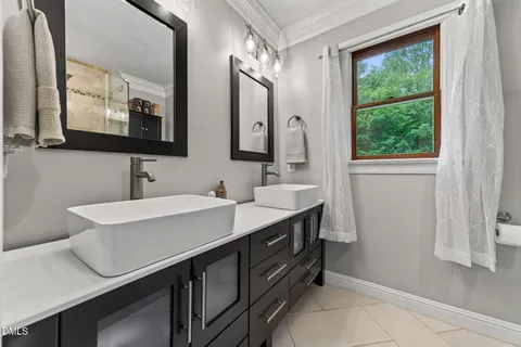a bathroom with a toilet sink vanity and mirror