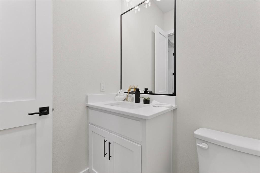 4961 County Road 1098 Celeste, TX 75423 - Photo 33 of 40 Bathroom featuring vanity and a textured wall