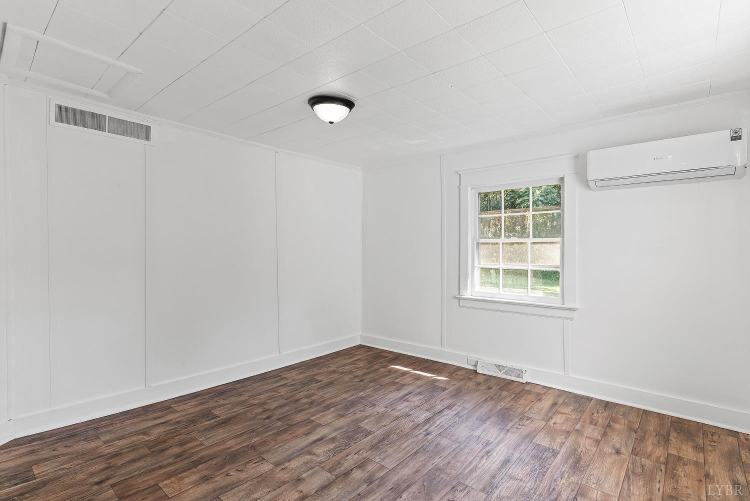 4970 Reedy Spring Road Spout Spring, VA 24593 - Photo 15 of 28 an empty room with wooden floor and windows