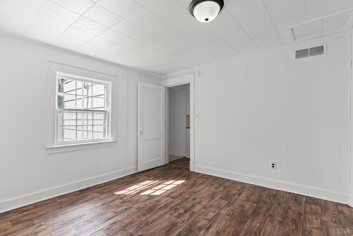 4970 Reedy Spring Road Spout Spring, VA 24593 - Photo 16 of 28 an empty room with wooden floor and windows