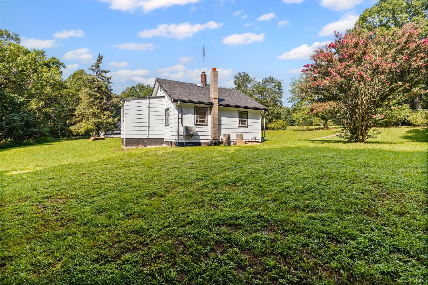 4970 Reedy Spring Road Spout Spring, VA 24593 - Photo 23 of 28 a view of a house with a big yard and large trees