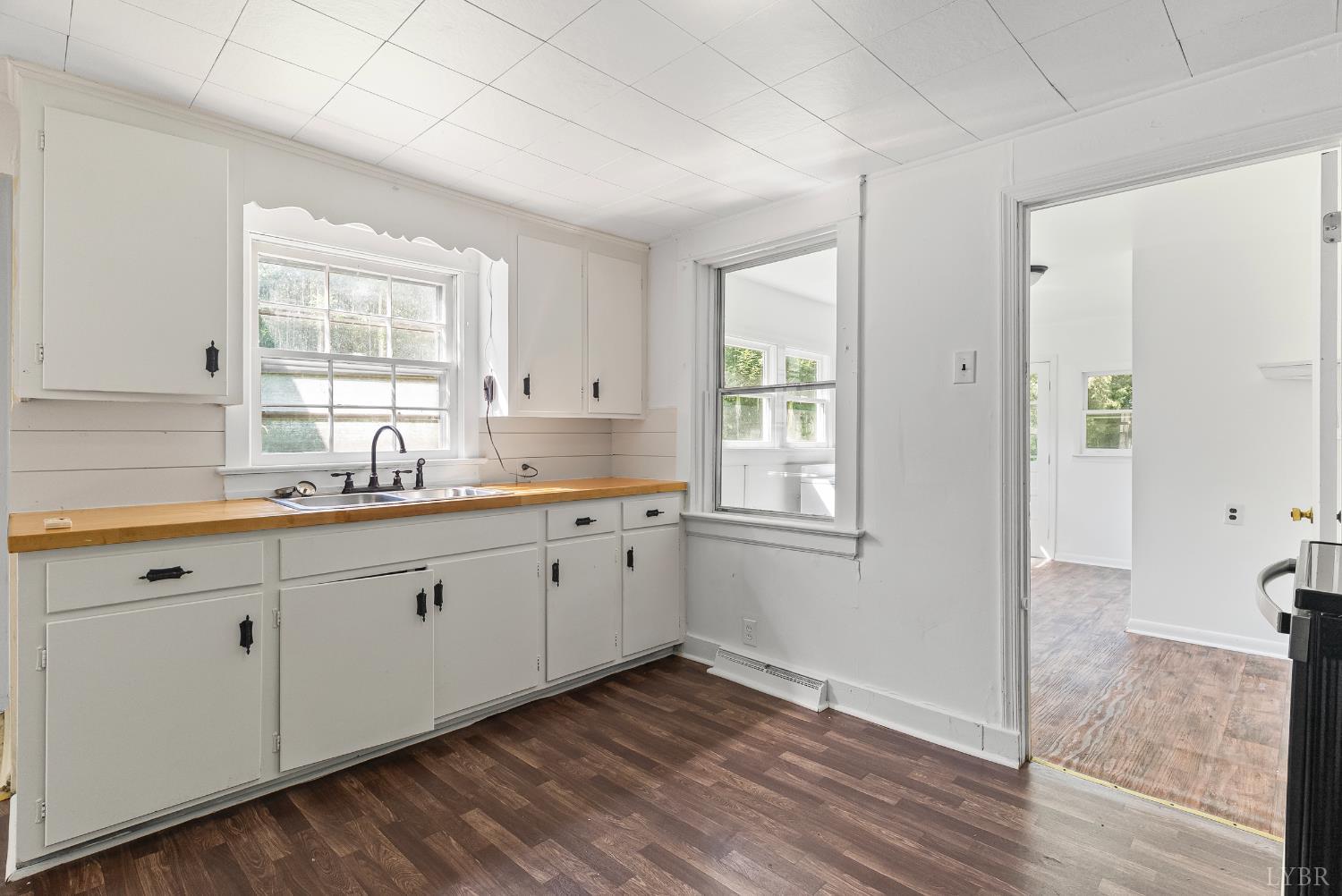 4970 Reedy Spring Road Spout Spring, VA 24593 - Photo 5 of 28 a large white kitchen with granite countertop a sink window and cabinets