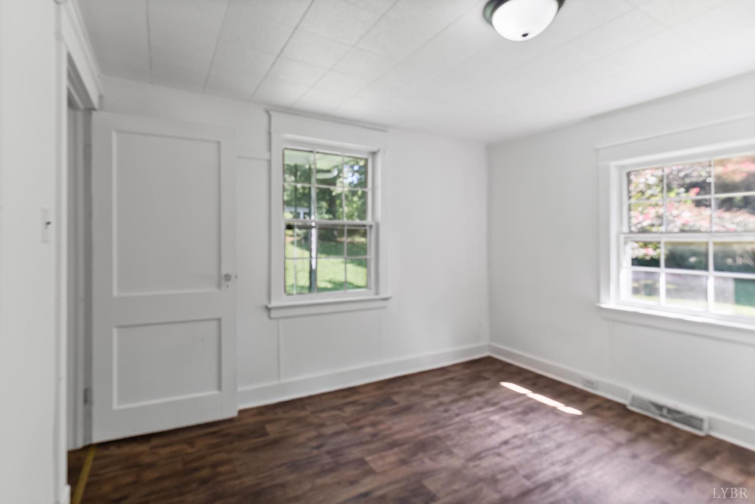4970 Reedy Spring Road Spout Spring, VA 24593 - Photo 9 of 28 an empty room with wooden floor and windows