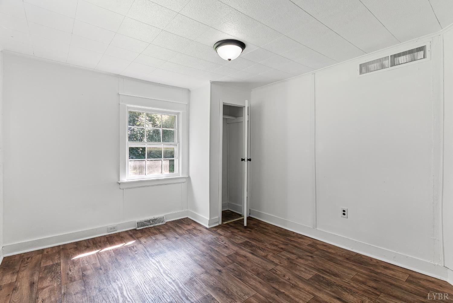 4970 Reedy Spring Road Spout Spring, VA 24593 - Photo 10 of 28 an empty room with wooden floor and windows