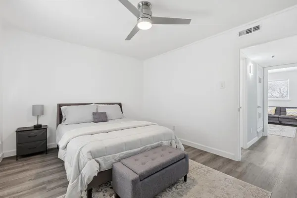 a bedroom with a bed and wooden floor