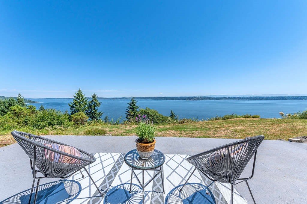 19102 Ridge Road Southwest Vashon, WA 98070 - Photo 17 of 29 a view of a chairs and table on the patio and a ocean view