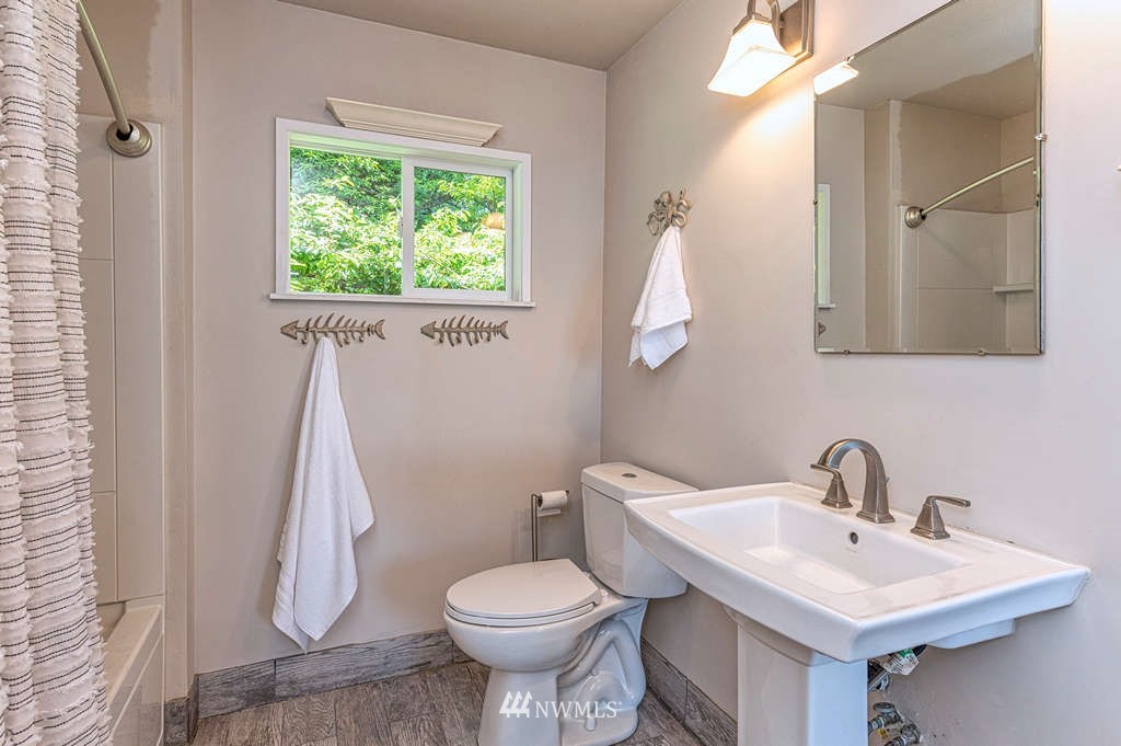 19102 Ridge Road Southwest Vashon, WA 98070 - Photo 10 of 29 a bathroom with a sink toilet and a mirror