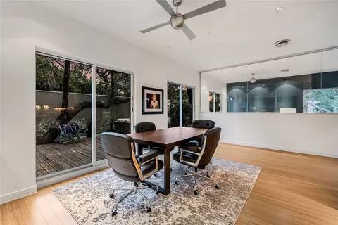 a view of a dining room with furniture and wooden floor
