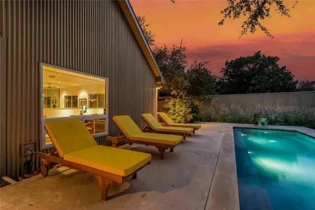 a view of a patio with chairs and a table