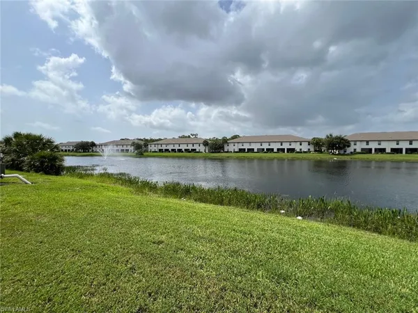 a view of a street with a cars park side of a road