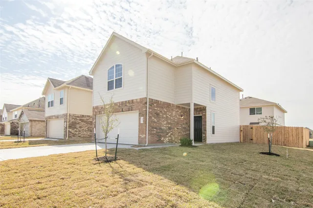a view of a large brick house with many windows