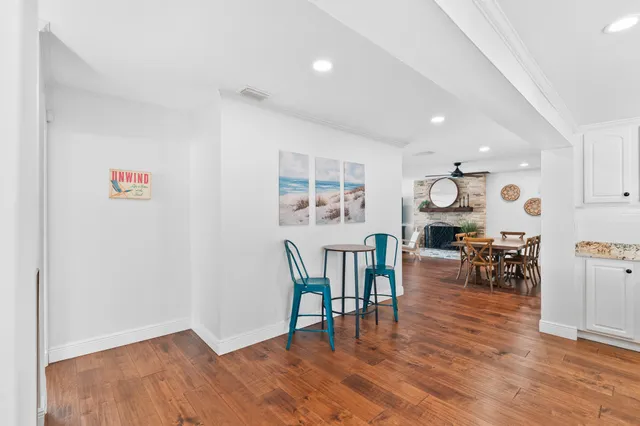 a bathroom with a granite countertop sink mirror vanity and toilet