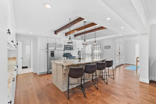 a spacious bedroom with a bed and a view of bathroom