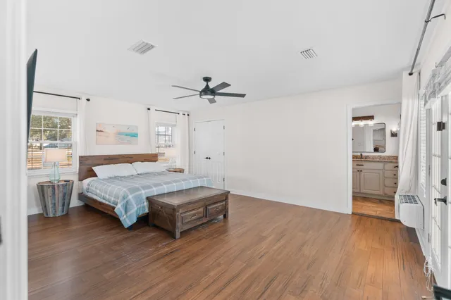 a bathroom with a sink double vanity granite tub and a mirror