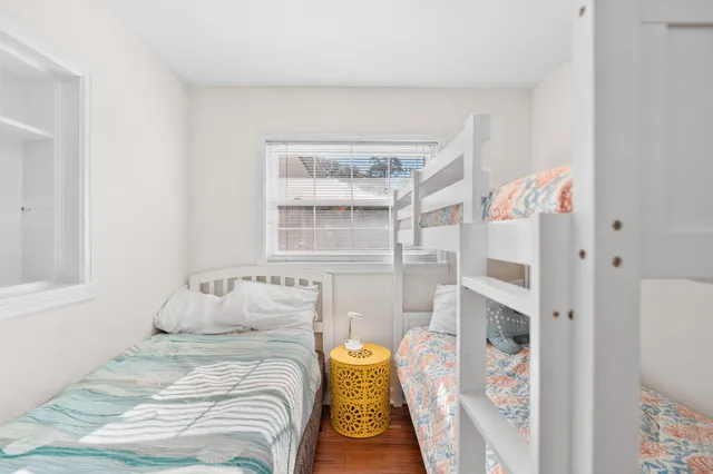 a view of a patio with a dining table and chairs with wooden floor and fence