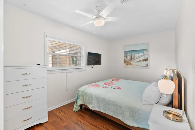 a view of a house with a yard and potted plants
