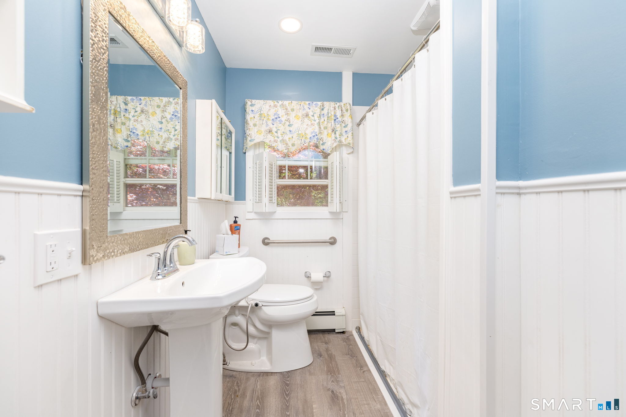 189 Bee Street Meriden, CT 06450 - Photo 17 of 39 a bathroom with a sink a mirror and a toilet