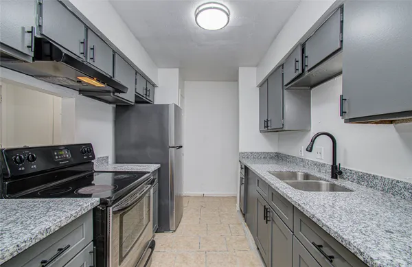 a kitchen with stainless steel appliances granite countertop a sink stove and cabinets